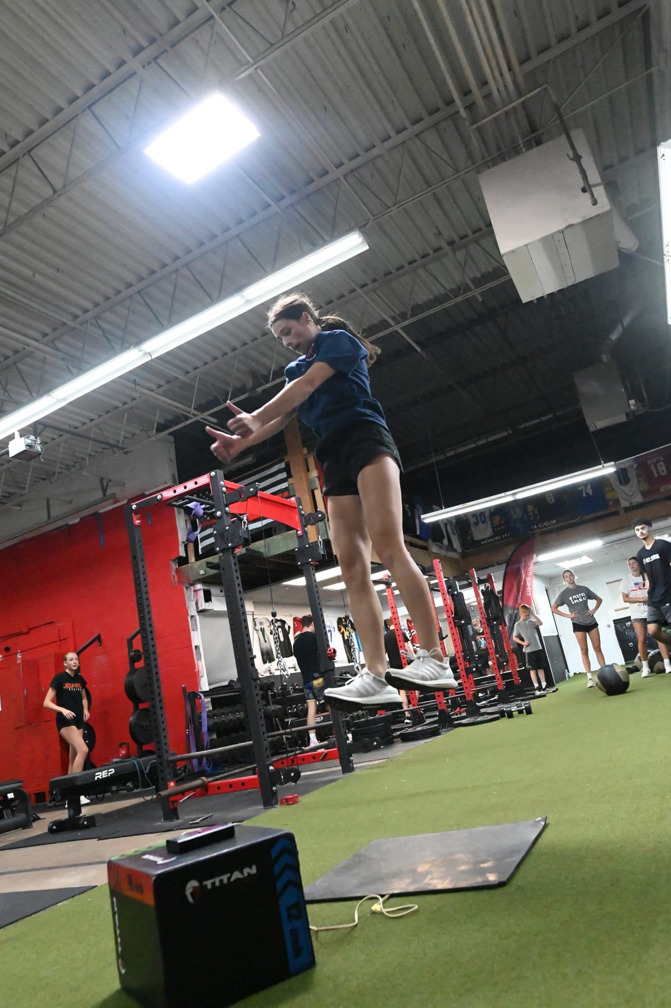 Athlete in the air above the jump mat during a vertical jump